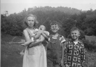 Weaver, Hazel, George, Dillard and Betty Waddell
This 1954 photo shows Hazel Weaver holding her neice Betty Waddell, with George Weaver and Dillard Weaver.  The Weavers were children of Arthur F. Weaver and Fannie Blevins.  Betty Waddell was the daughter of George Waddell and Mattie Weaver.  Photo by Clarence Weaver.
