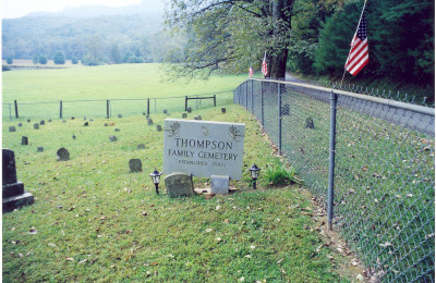 Thompson_Cemetery__1.jpg
Description: Ann Combs, Beam a descendant of the Thompson family of Surry County, North Carolina came down from Alexandria, Virginia in October of 2003. She and her husband came by to see me for a few minutes and then went by Devotion. The gatekeeper of the Reynolds estate allowed them to go inside to the Thompson cemetery. 
Directions from the gate to the Thompson Homestead and Graveyard site:Get Permission at the gatehouse
Go through gate for 3 10ths miles on right, inside fence. Mitchell's River and the creek flow on either side. 
Buried here are Martha Thompson wife of Hiram Higgins. (Hiram was killed in the Civil War and Martha was murdered by John Jack Mayes and burned in her house ) The cemetery is being kept in very good condition.  Courtesy of Nanalee Wrenn [email]nwrenn37@yadtel.net[/email]
