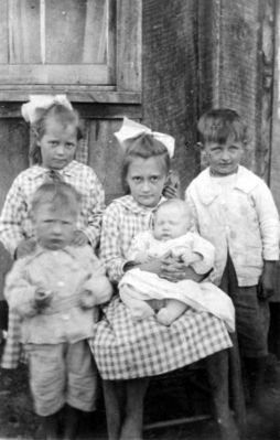Daddyboy.jpg
This photo is of my father Ira Johnson and his siblings, taken probrably in early 20's. From left to right: Florence is standing with her hands on John's shoulders. Juanita, seated, is holding baby Melvin and Daddy (Ira) is holding on to the chair. Daddy almost always wore that little grin and a light in his eyes.  Courtesy of Lesa Long [email]ladygwenhwyvar@hotmail.com[/email]

