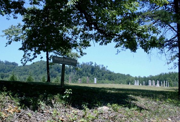Haystack Road
The sign on the side of the road and the graves in the background.   You can see what a great job someone has done to clean up and maintain the place. 

Date Taken: 6/22/02 

Place Taken: Haystack Road near Devotion in Surry County, NC

Courtesy of Nanalee Wrenn

