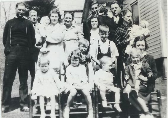 WadeandDentonJonesfamily.jpg
first row (l to r): Freda Jones, Mary Jones (my mother), Phil Stanley, Irene Jones Weaver holding Patsy Jones.  2 boys behind chairs: Lloyd Dean Jones, J. B. Jones. back row standing (l to r) Wade Jones Jr. 9my grandfather), Della Yates Jones (my grandmother) holding Bobby Jones, Denton Young Jones (my great-grandmother), Emma jones Stanley, behind her Virgil Stanley, peeking from behind Virgil is Elmo Jones, beside Virgil is Gilmer Jones, Ruth Jones holding son Tom Jones.  Courtesy of Danny Miller [email]millerd@fuse.net[/email]

