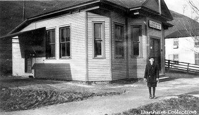 Salrville - Post Office and Harry Dunham
HARRY S. DUNHAM OF SALTVILLE, VA.  AT AGE 12...STANDING IN FRONT OF SALTVILLE'S THIRD POST OFFICE IN 1918.  THIS POST OFFICE WAS BUILT ABOUT WHERE CARLTON CHAPMAN'S FIRST CHOICE FLOWER SHOP IS PRESENTLY LOCATED.  HARRY WAS BORN DEC. 4, 1906 AND DIED ON JAN. 8, 2001 AT THE AGE OF 94.
 
THE FIRST POST OFFICE WAS LOCATED IN THE "OLD STORE" AT THE LOWER END OF SMOKEY ROW.  THE SECOND POST OFFICE WAS IN THE MATHIESON GENERAL STORE NEAR THE MEAT MARKET.  THE FOURTH ONE WAS MOVED A COUPLE OF DOORS UP THE STREET FROM THE ONE PICTURED.  FROM THERE, POST OFFICE NUMBER FIVE WAS LOCATED IN A BUILDING WITH THE BOWLING ALLEY, JAIL  AND POLICE STATION.
 
NUMBER SIX WAS BUILT IN 1931 AND WAS USED UNTIL 1966.  THIS BUILDING CURRENTLY HOUSES THE SALTVILLE LIBRARY.
 
IN 1966, THE PRESENT DAY POST OFFICE WAS OPENED FOR BUSINESS.  Coirtesy of Don Smith [email]dsmith1043@cmcast.net[/email]
 

