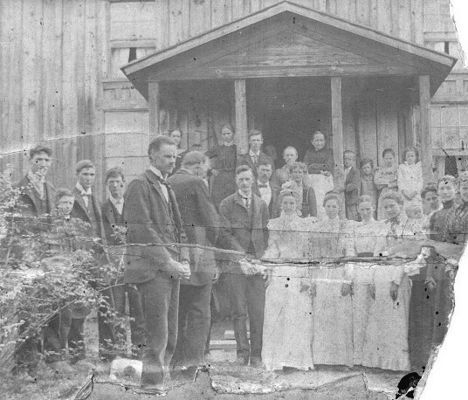 Foster Falls 1901
It is the wedding day picture of my grandparents, Eli Mabry and Mary Ann Lucinda "Cindy" Williams. 8 May 1901, Foster Falls, VA (possibly McNealy and Eliza (Davis) Williams' home)

Groom: Eli Mabry/Maberry, 27 yr. old
Bride: Mary Ann Lucinda "Cindy" Williams, 22 yr. old
Leaning against left center post: Ballard Mabry 
Center, beside Ballard: Mindy (Largen) Mabry, Ballard's wife
Leaning against right center post: Possibly Eliza (Davis) Williams (I was told she had broken her back and it left her stooped over)
Behind bride and groom: John and Roxie (Mabry) Dillon 
Front: Isaac Mabry 
Behind Isaac may be Martin Mabry (Eli's father)
Second from the bride: Sarah Jane (Mabry) Dalton 
Third from the bride: Emma (Mabry) Alderman 
Beside bride: unk (probably a sister of Lucinda's, Jeanetta "Nettie" (Williams) Easter or Malinda "Ellen" (Williams) Frazier)
Second from far right: Roxie (Mabry) Dillon 
Far right: Lucy (Mabry) Williams
Far left: Virgil or Charles Williams?
Second from left: Steve Williams
Third from left: Bert Williams
Forth from left: David Williams
Courtesy of Rita Mayberry.
