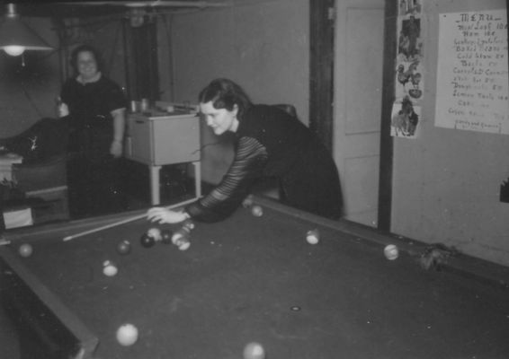 poolhall1.jpg
This 1938 John Porter shows a woman playing a game of pool.
