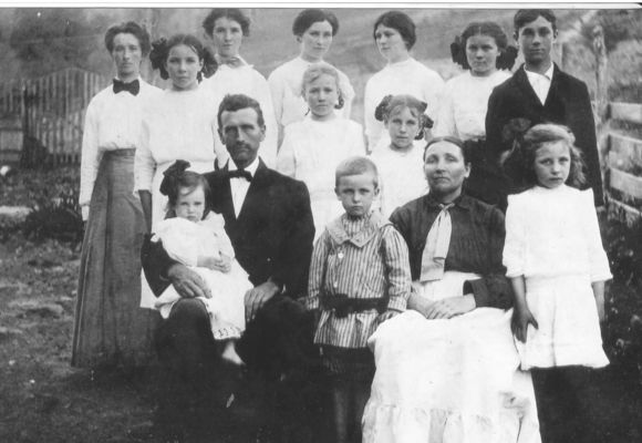 Kilby, Roby
Roby and Eva Osborne Kilby with 12 of their 15 children taken in 1911/12 in the Sturgills area of Ashe County, NC. The oldest was born in 1890 and the youngest pictured in 1910. [L-R, top row with married names in parentheses] Jenny (Young), Ollie (Weaver), Emaline (Duncan), Virgie (Norman), Minnie (Sturgill)  [middle row] Lola (Sewell), Elsie (McCommons), Ruth (Umbarger), Dewey Kilby [bottom row] Lucy (Stewart) on lap of James Roby Kilby (son of Thornton Kilby and Phebe Marilda Weaver) Thornton Kilby, Ruth Eva Kilby  (daughter of Wiley Winton Osborne and Lavina Jane Mink), Mary (Eppers).  Courtesy of Emily Kilby.  [email]erk44@verizon.net[/email].

