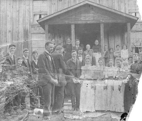 Foster Falls 1901
It is the wedding day picture of my grandparents, Eli Mabry and Mary Ann Lucinda "Cindy" Williams. 8 May 1901, Foster Falls, VA (possibly McNealy and Eliza (Davis) Williams' home)

Groom: Eli Mabry/Maberry, 27 yr. old
Bride: Mary Ann Lucinda "Cindy" Williams, 22 yr. old
Leaning against left center post: Ballard Mabry 
Center, beside Ballard: Mindy (Largen) Mabry, Ballard's wife
Leaning against right center post: Possibly Eliza (Davis) Williams (I was told she had broken her back and it left her stooped over)
Behind bride and groom: John and Roxie (Mabry) Dillon 
Front: Isaac Mabry 
Behind Isaac may be Martin Mabry (Eli's father)
Second from the bride: Sarah Jane (Mabry) Dalton 
Third from the bride: Emma (Mabry) Alderman 
Beside bride: unk (probably a sister of Lucinda's, Jeanetta "Nettie" (Williams) Easter or Malinda "Ellen" (Williams) Frazier)
Second from far right: Roxie (Mabry) Dillon 
Far right: Lucy (Mabry) Williams
Far left: Virgil or Charles Williams?
Second from left: Steve Williams
Third from left: Bert Williams
Forth from left: David Williams
Courtesy of Rita Mayberry.
