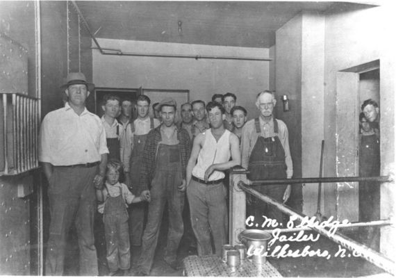 Wilkes Co jail
Wilkes Co jail.  "C. M. Elledge, Jailer, Wilkesboro, NC".  Josh Pruitt (1871-1950) is in the back, just right of the man in front wearing the hat.  Court records show that Josh was in jail in 1921 and 1922 for making moonshine.  Courtesy of Jason Duncan 

